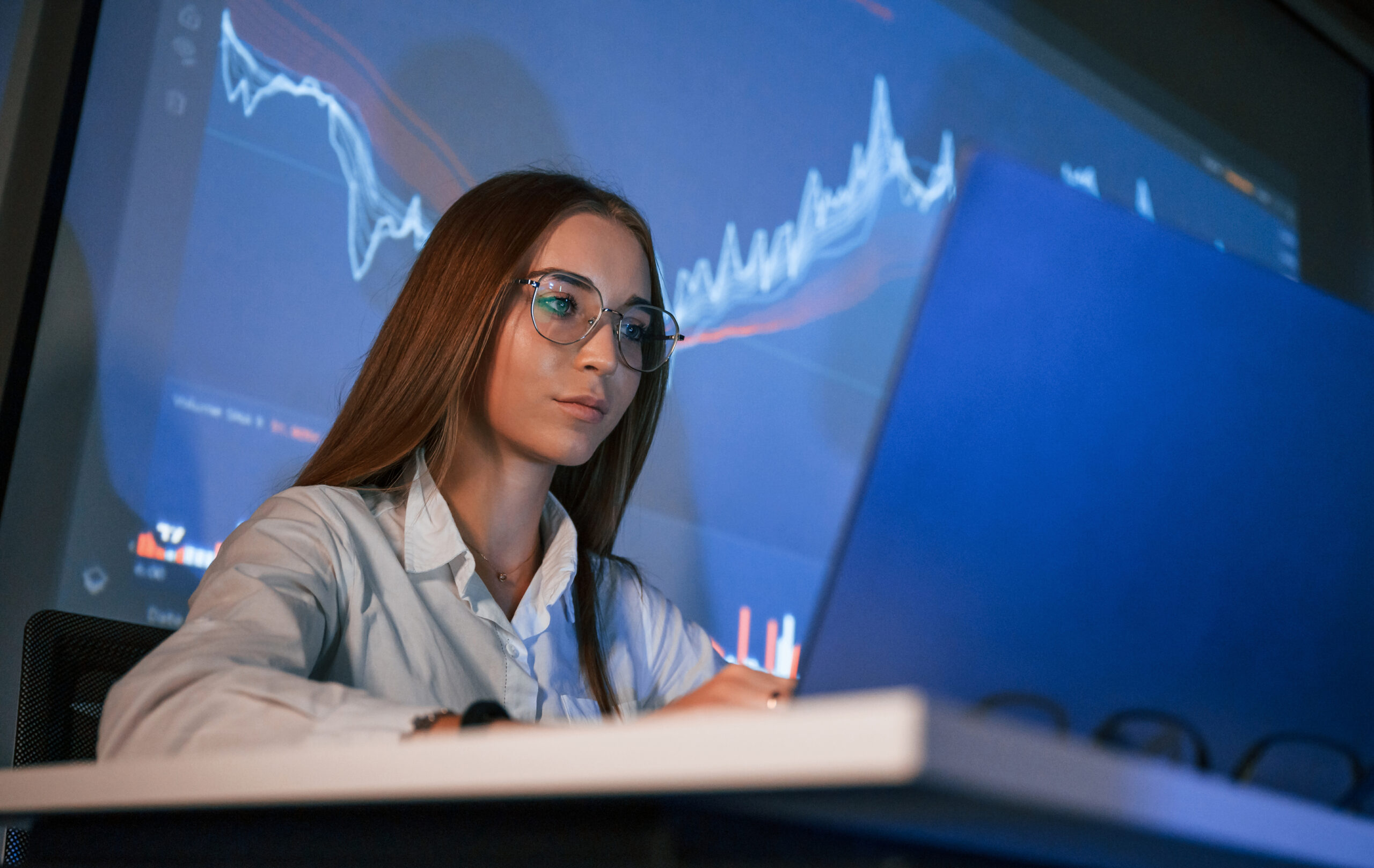 woman analyzes financial data on computer screen utc